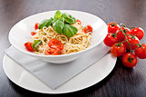 fresh tasty pasta spaghetti with tomatoes and basil