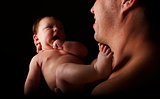 father with a young child on a black background