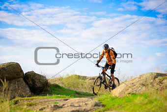 Cyclist Riding the Bike on the Beautiful Mountain Trail