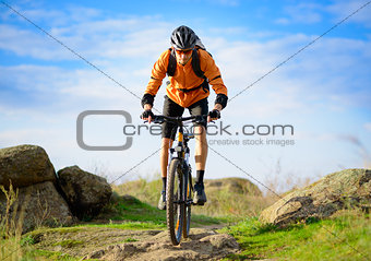Cyclist Riding the Bike on the Beautiful Mountain Trail