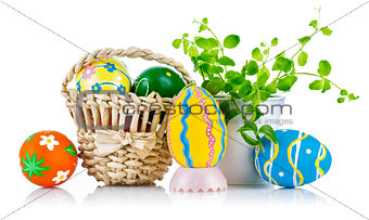 easter eggs in basket with spring leaves