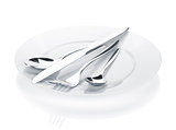 Silverware or flatware set of fork, spoons and knife over plates
