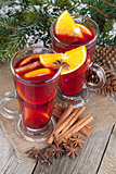 Christmas mulled wine with spices and snowy fir tree
