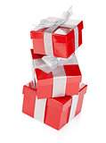 Three red gift boxes with silver ribbon and bow