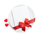 Valentine's Day love letter over plate with red bow