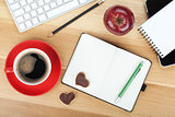 Coffee cup, cookies, red apple and office supplies