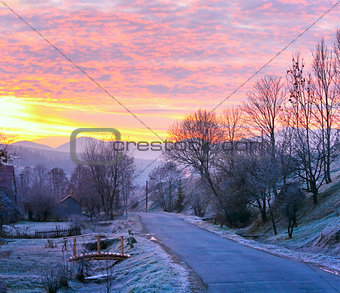 Sunrise and mountain village road