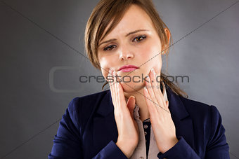 Closeup portrait of a young businesswoman having toothache