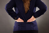 Closeup of businesswoman with back pain 
