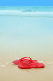 Red flip flops on the beach