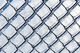 Ice coated chain link fence from an ice storm