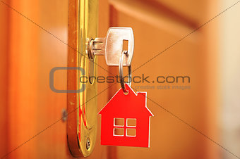 A key in a lock with house icon on it