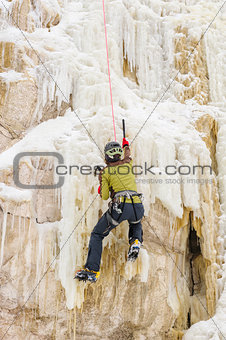 Young man climbing the ice