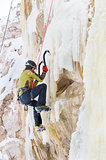 Young man climbing the ice