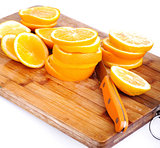 cut oranges on kitchen board