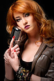 Beautiful redhead girl with retro microphone 