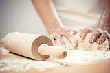 Woman kneading dough, close-up photo