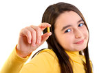 Young girl holding capsule