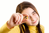 Young girl holding and analizing capsule