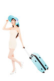 Fashionable woman running with suitcase