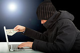 Computer hacker stealing money  in the darkness