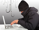  hacker working  with a laptop computer and hooks