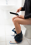 young man in toilet using tablet