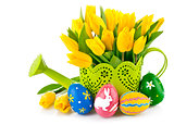 easter eggs with yellow tulips in watering can