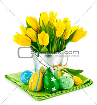 easter eggs with yellow tulips in bucket