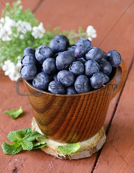 fresh organic ripe blueberries in a wooden bowl