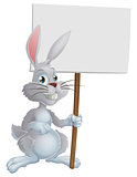 White Easter bunny holding sign