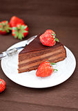 Piece of chocolate cake decorated with fresh strawberry