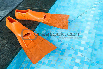 Orange Rubber flippers in pool