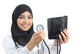 Saudi arab woman showing a sphygmomanometer