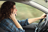 Side view of a woman driving a car and talking on the phone