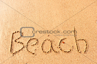 word written on beach wet sand