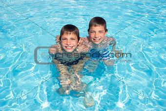two happy friends swimming in the pool