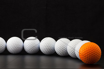 Golf balls on the black background