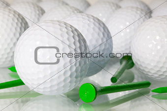 Many golf balls on a glass table