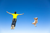relaxing young man and  dog jumping in the sky