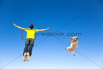 relaxing young man and  dog jumping in the sky
