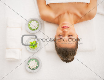 Portrait of young woman laying on massage table