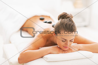 Young woman receiving hot stone massage