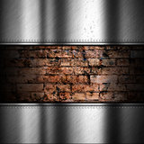 Brushed metal background with brick