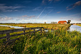 fence and farmhouse in Dutch farmland