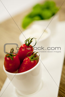 tasty tomatoes mazarella and basil on plate on table