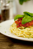 delicious fresh spaghetti with tomato sauce and parmesan on table