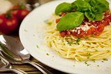 delicious fresh spaghetti with tomato sauce and parmesan on table