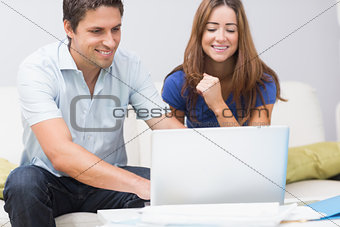 Cute couple using laptop at home