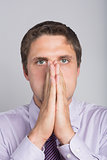 Green eyed businessman with hands covering face